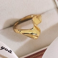 Detailed macro view of the gold irregular wave open ring on a beige velvet jewelry box - Irregular Wave Style (13333H)