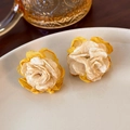 Detail of elegant cream and yellow mesh flower earrings on a white ceramic tray - Beige Mesh Flower (22895)