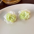 Macro shot of delicate light green mesh flower earrings on white ceramic plate - Green and White Flower (23534B)