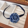 Close-up of a dark blue denim rose choker featuring raw edges in a wooden jewelry tray - 12# Dark Blue Denim Choker (23884A)