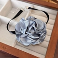 Detailed view of the blue fabric flower choker in a velvet lined wooden jewelry box - 19# Grey Blue Satin 3D Large Flower (24442C)