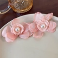 Detailed close-up of pink mesh flower earrings with central pearl on a beige plate - Soft Pink Pearl Flower (23878B)