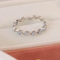 Macro shot of wave-shaped silver adjustable ring featuring five blue zircons in jewelry box - Adjustable Open / Blue Zircon Wave Style(25092B) / Silver