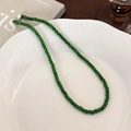 Macro view of green beaded necklace with silver toggle clasp on white ceramic tray - 4mm / 4mm Necklace