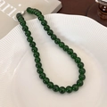 Detailed macro view of deep green beaded necklace featuring silver metallic clasp - 10mm / 10mm Necklace