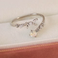 Macro shot of silver floral adjustable ring with opal and pavé cubic zirconia details - White Zircon Foliage Style(25097B)