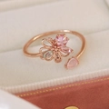Close-up of rose gold flower ring with pink crystals on beige jewelry box lining - Pink Zircon Blooming Style(25099A)
