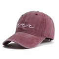 Detail view of the embroidered white wave pattern on a washed burgundy cotton baseball cap - One Size / Burgundy