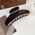Detail of large dark brown acetate hair claw clip with France Handmade gold lettering - Glossy Brown