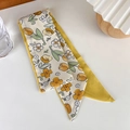 Detailed view of a dual-sided yellow tulip silk scarf with satin finish and floral print - Tulip
