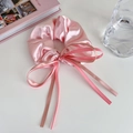 Detailed view of pink satin scrunchie with long ribbon streamers and silky texture - Large / Pink