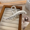 Detailed view of silver wave-shaped metal shark hair claw clip for thick hair - Silver