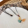 Macro detail of butterfly pendant with colorful resin and gold foil on woven rope - Butterfly Style (A Multicolor Butterfly) / Multicolor Butterfly