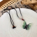 Detail of butterfly necklace with green translucent resin and gold flakes on black cord - Butterfly Style (B Green Butterfly) / Green Butterfly