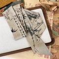 Detail shot of ink landscape silk scarf on vintage scroll and wooden tray setting - Misty Rain and Bamboo