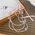 Detail of multi-layer beaded necklace featuring pink silk ribbons and butterfly pendants - Bow Pendant Style / Pink