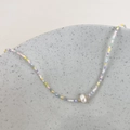 Detailed shot of handmade colorful macaron beads necklace with a central freshwater pearl - Purple Multicolor Beads