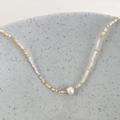 Macro shot of colorful seed beads and a natural freshwater pearl on an elegant necklace - Yellow Multicolor Beads