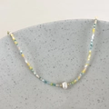 Detail of colorful beads and a freshwater baroque pearl on a stylish collar necklace - Green Multicolor Beads