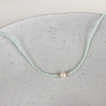 Detailed macro view of light blue seed bead necklace with center freshwater pearl accent - Lake Green Beads 1