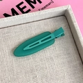 Close-up of a matte peacock green duckbill hair clip on a minimalist display tray - Duckbill Hair Clips / Dark Green