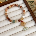 Detail of beaded bracelet with vintage flower pendant and green jade bead on white velvet - Jade Pendant Flower Style (23648G)