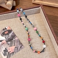 Detail of colorful dopamine glass bead necklace on a beige linen tray with retro vibes - Leopard And Star Mixed Pattern Style (5# 23643B)