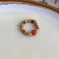 Detail view of handmade beaded ring with brown wooden beads and a red agate stone accent - Red Agate Coffee Beads (23973B)