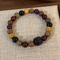 Macro view of sandalwood beads bracelet with engraved barrel bead and mixed wood textures - Ebony Style (23996B)