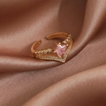 Detail of a golden open ring with a pink star gemstone and micro-pave crystals - Gold Pink Pentagram Star (23944)