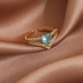 Detail of gold open ring featuring a blue heart gemstone and V-shaped pavé setting - Gold Blue Heart Style (23947)