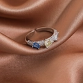 Close-up of silver open ring with heart and rectangle gemstones on red silk fabric - Silver Pave Three Rhinestones (23934C)
