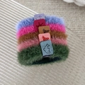 Close-up of five colorful plush hair ties with leather tags on a textured tray - Dark Color Style (24227B)