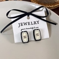 Macro shot of vintage French style square earrings with black enamel and white pearls - B Black