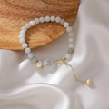 Detailed macro of jade bead bracelet with safety buckle and freshwater pearl accents - Pale Green and White (Main Style)