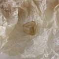 Detail of wide resin ring with amber and beige marble texture on brown paper - Round Style