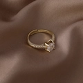 Macro view of adjustable gold-plated ring with round zircon and pavé setting on silk - Square Single Zircon Style (16344)