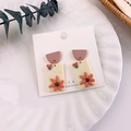 Handmade floral drop earrings with purple semicircle and orange flowers on white plate - Starfish Shape Style (D 海星)