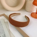 Detail of a brown corduroy headband with a non-slip lining on a wooden photo frame - Brown
