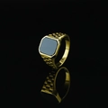 Men's titanium steel signet ring featuring a black gemstone and a polished gold finish - US 7