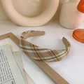 Detailed view of a brown plaid headband featuring thick corduroy fabric and sponge padding - Khaki Plaid