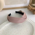 Detail of pink PU leather wide cross-knot headband with texture on a white tray - Lotus root pink