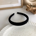 Detailed macro view of black puffy fabric headband showing handmade text and soft texture - Black Fine Texture Fabric (17723J)