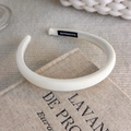 Detail view of white padded headband with handmade label on rustic book background - Twill Fabric Style (26698A)