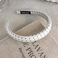 Detail showing white polka dot fabric headband with a black handmade woven label tag - Polka Dot Fabric Style (25673A)