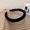Detail of a black knit braided headband with anti-slip teeth and elegant French style - Black Knit Twist Braided (19229)