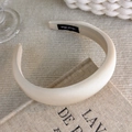 Close-up of a cream thick padded headband with a silk texture and Hand Made label - Solid Padded Style (20118A)