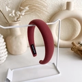 Detailed macro view of the dark red knitted sponge headband with a black Hand Made label - Ribbed Thickened Style / Carmine