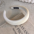 Detail of cream sponge headband with handmade label on vintage book background - Padded Matte Style (19347A)