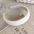 Macro shot of a thick cream velvet headband resting on a vintage book for a soft look - Cream Rounded Style (27077A)